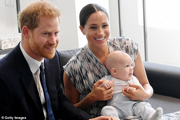 The King and Meghan Markle (pictured with Prince Harry and their son Prince Archie in September 2019) have a 'pleasant but distant relationship' after a 'respectful back and forth' via letter over two Royal Family members who made comments about Archie's skin colour, Omid Scobie has claimed